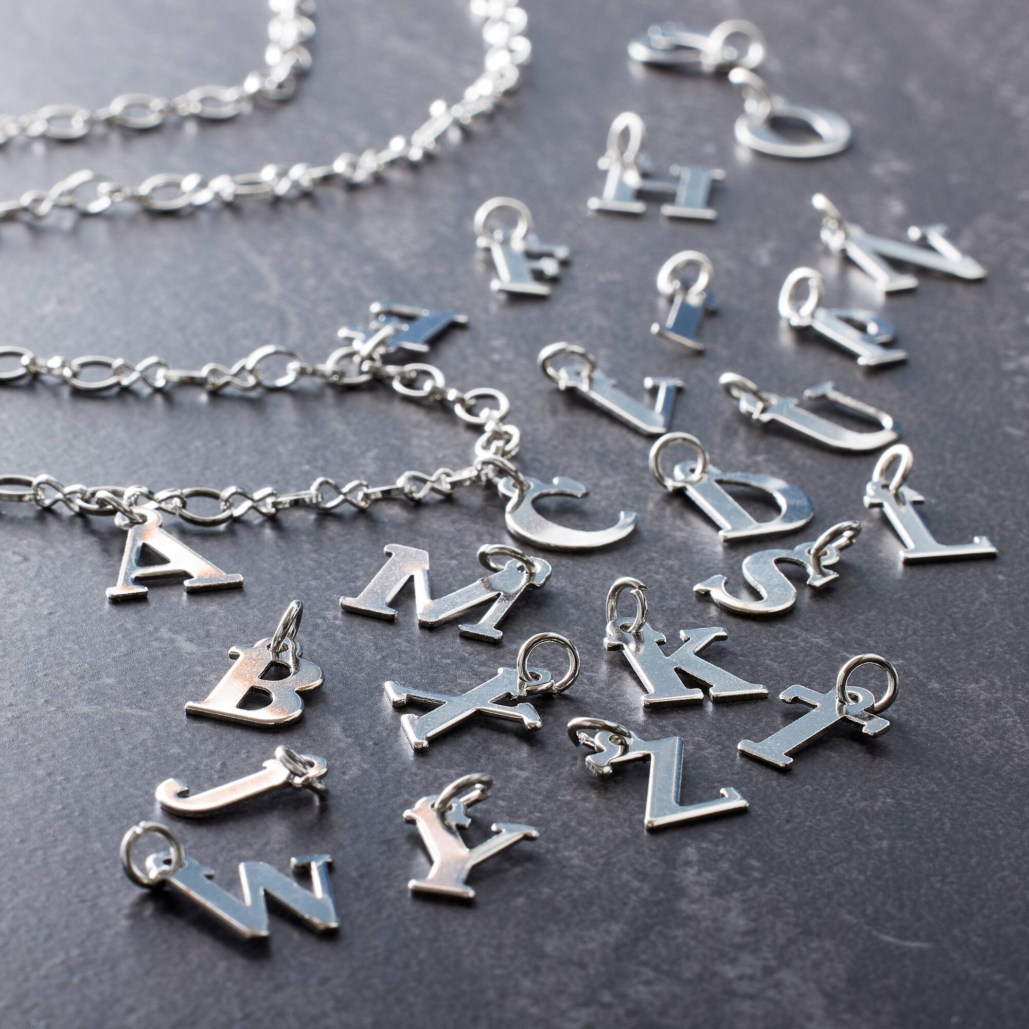 12 Packs: 26 ct. (312 total) Alpha Capitals Charms by Bead Landing™